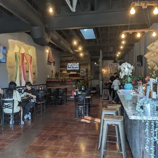 people sitting at tables in a restaurant