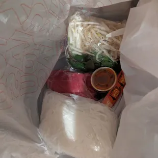 How they packaged the meat, additional veggies, noodles, sauces and utensils