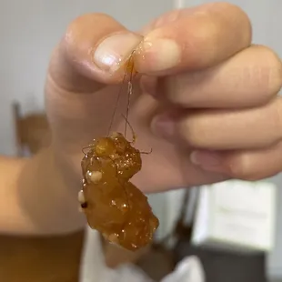 a person holding a piece of food