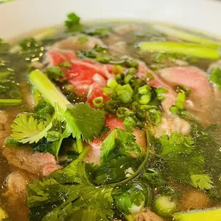 a bowl of soup with meat and vegetables