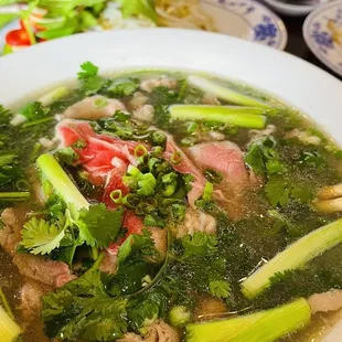 a bowl of soup with meat and vegetables