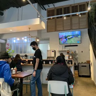 people sitting at tables in a restaurant