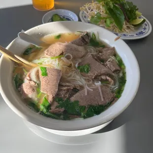 large brisket, tendon, tripe, side of peppers and sprouts, cilantro.