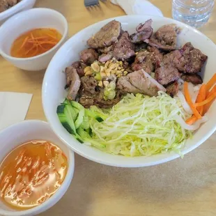 Grilled pork vermicelli bowl, and a single use plastic bottle of water.