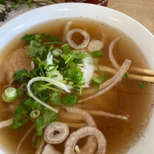 a bowl of soup with noodles and meatballs