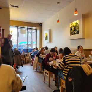 people sitting at tables in a restaurant