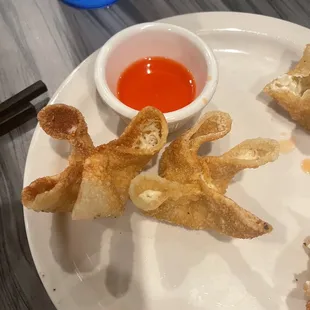 a plate of food with dipping sauce