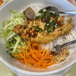 Chicken rice noodle dish with one pork piece from another dish