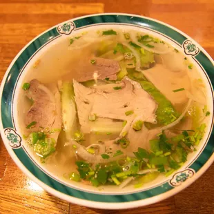 a bowl of soup with meat and vegetables