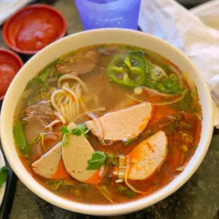 a bowl of soup with meat and vegetables