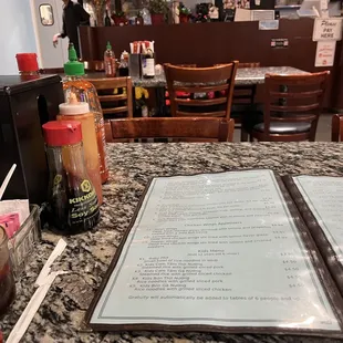 a table with a menu and drinks