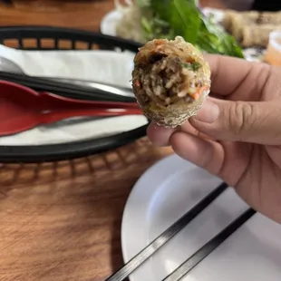 a person holding a piece of food