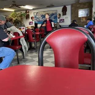 people sitting at tables in a restaurant