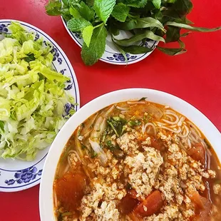 a bowl of soup and a plate of salad