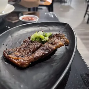 a steak on a black plate