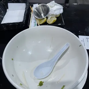 a white bowl with a spoon in it