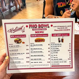 a person holding a menu