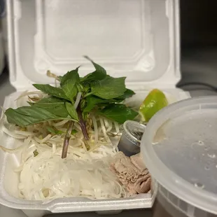 a container of food and a container of soup