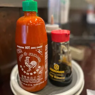 a bottle of hot sauce on a plate