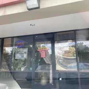 Entrance some parking next to a laundromat