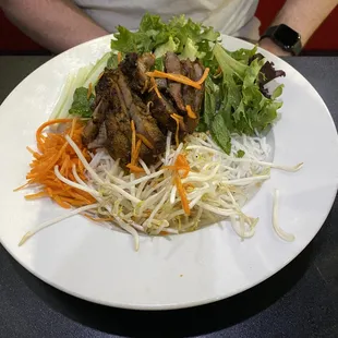 a plate of food with meat and veggies