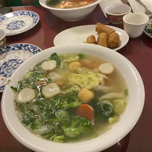 a man sitting at a table with a bowl of soup