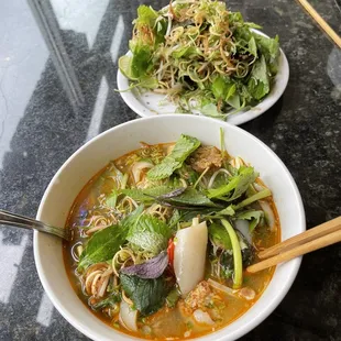 two bowls of soup and a salad
