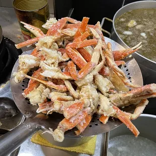 a pile of crab legs being cooked