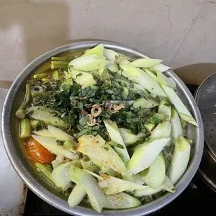 a bowl of vegetables on a stove