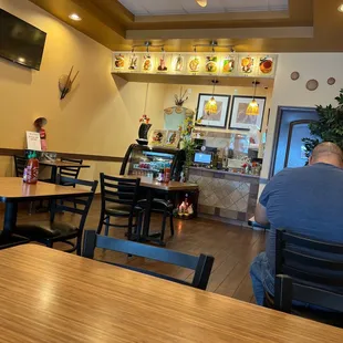 a man sitting at a table in a restaurant