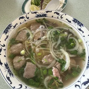 a bowl of soup with meat and vegetables