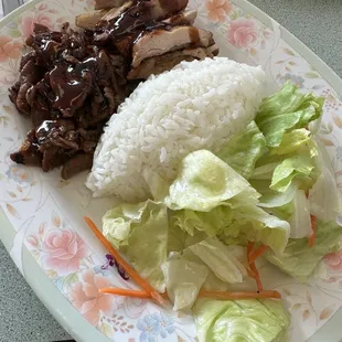 a plate of rice, meat, and lettuce