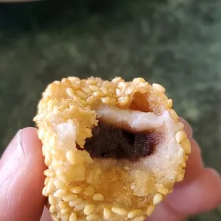 a hand holding a pastry