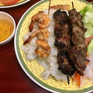 Com Thit Tom: Grilled shrimp and pork over rice served with greens and a sweet chili sauce