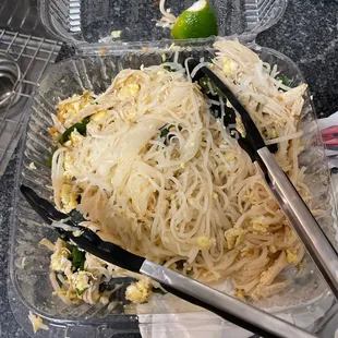 a bowl of noodles with chopsticks