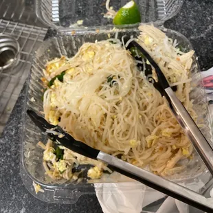 a plate of noodles and chopsticks