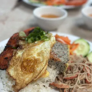 a plate of rice, meat, and vegetables