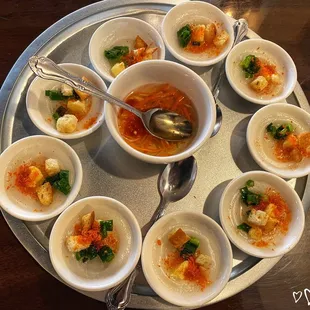 a variety of small bowls of food