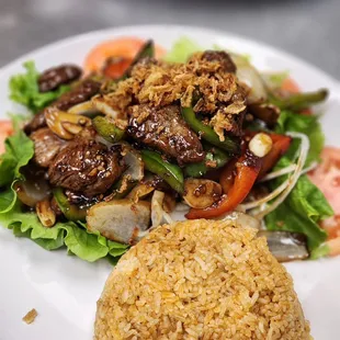 a plate of food with rice and meat