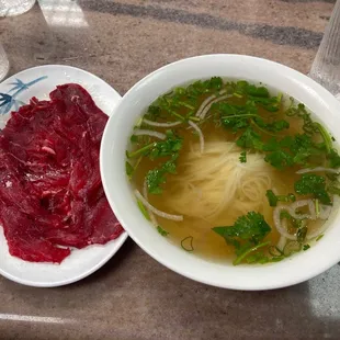 a bowl of soup and a plate of beef