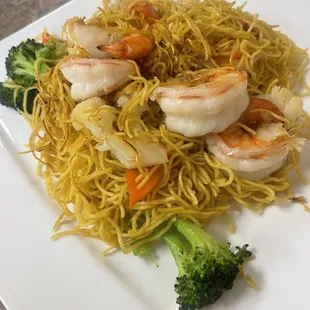 a plate of noodles with shrimp and broccoli