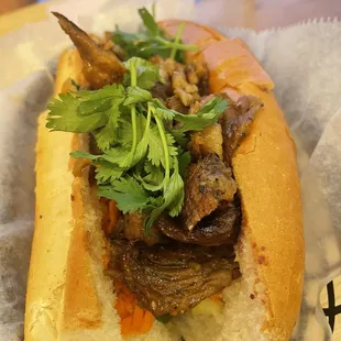 a sandwich with meat and vegetables