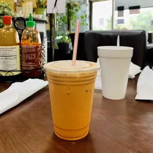 a drink in a plastic cup with a straw