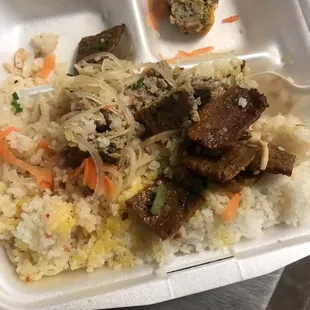 a tray of rice with meat and vegetables