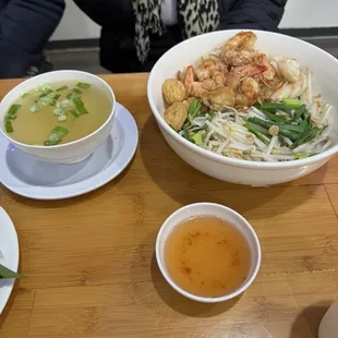 Combination meat on dry egg noodles with soup on side.