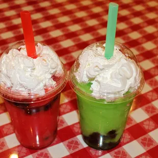 two cups of ice cream with strawberries and strawberries