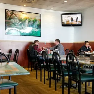 people sitting at tables in a restaurant