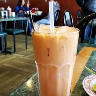 a glass of iced coffee on a table