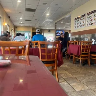 people sitting at tables in a restaurant