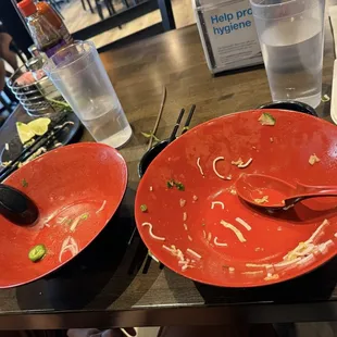 Sorry empty dishes from a delicious food. Pho and a bowl.